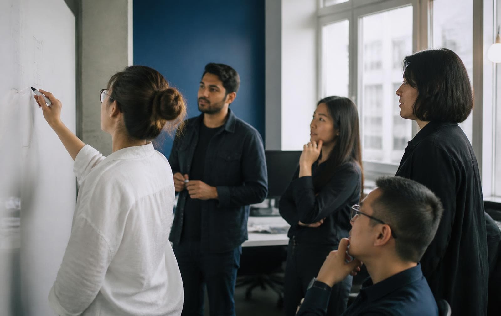 DevYet team discussing a product at a whiteboard