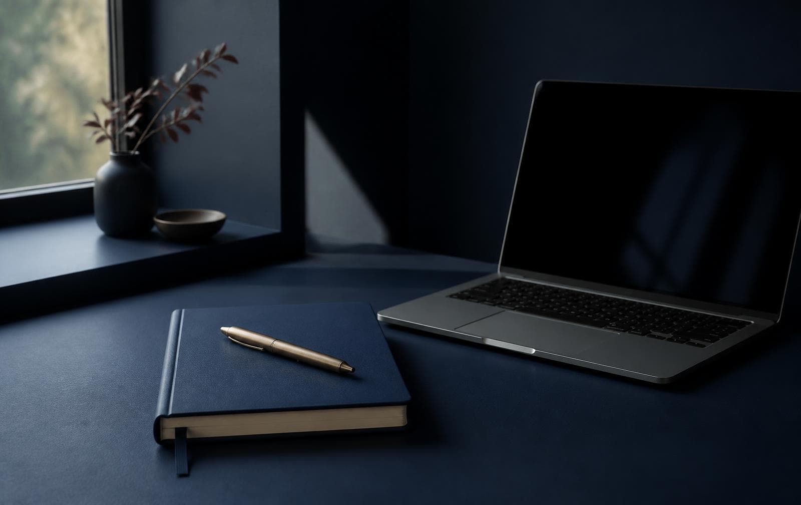 Notebook and laptop on a desk